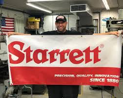 Adam Booth holding Starrett Sign
